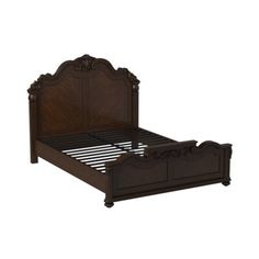 a wooden bed frame with carvings on the headboard and foot board, made in dark wood