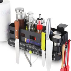 an assortment of kitchen utensils and knives are arranged in a black holder on a white background