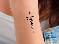 a woman's arm with the word faith written in cursive writing on it