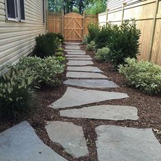 a stone path in front of a house