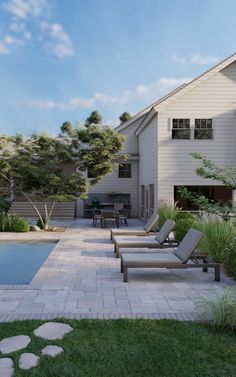 a backyard with a pool and lawn furniture