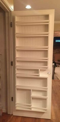 an empty white book shelf in a room