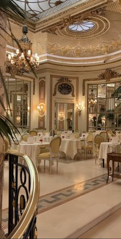 a fancy dining room with chandeliers and tables