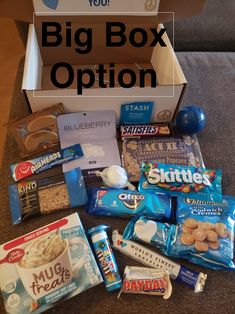 a box filled with snacks and candy on top of a couch