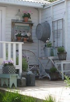 the porch is full of potted plants and other things to plant on it's side