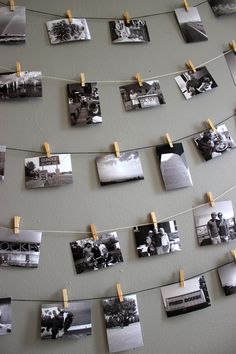 many pictures are hung on clothes pins and pinned to the wall