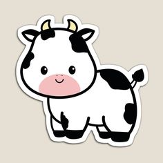 a black and white cow sticker sitting on top of a brown wall next to a gray background