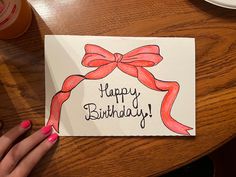 a woman's hand holding up a card with the words happy birthday on it