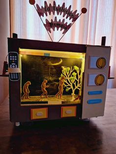 an old tv with some animals on it's side and the screen is lit up