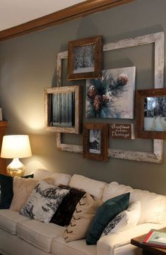 a living room filled with furniture and framed pictures on the wall above a white couch