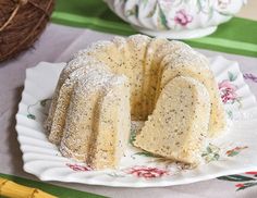 a bundt cake sitting on top of a white plate next to a green table cloth