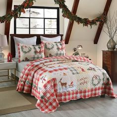 a christmas themed bed in a bedroom with red and white checkered bedspread