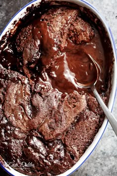 a chocolate cake in a bowl with a spoon