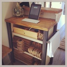 a laptop computer sitting on top of a wooden table