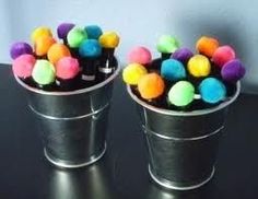 two buckets filled with gummy bears sitting on top of a table next to each other