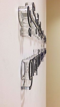 two glasses are hanging on the wall next to each other