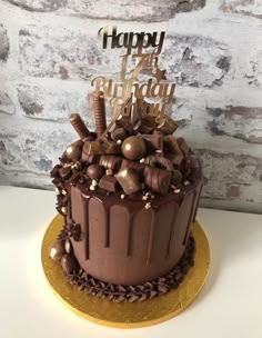 a birthday cake with chocolate frosting and decorations