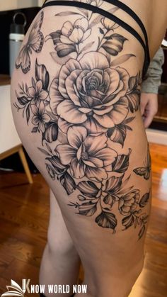 a woman's thigh with flowers and butterflies on the side, in black and white