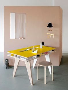 a yellow table and chair in a room