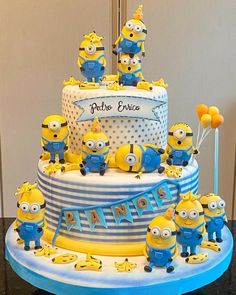 a three tiered cake with minion decorations on it