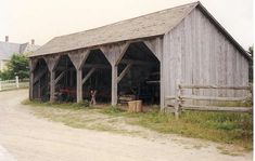 an old wooden barn with several open doors