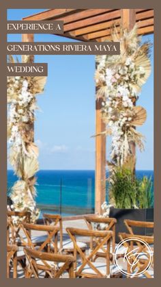 an outdoor wedding venue overlooking the ocean with white flowers and greenery hanging from the ceiling