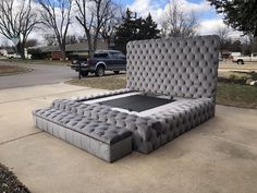 a large bed sitting on top of a sidewalk