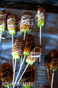 caramel apple slices are arranged on sticks