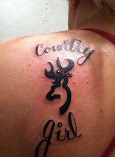 the back of a woman's shoulder with tattoos on it that says country girl