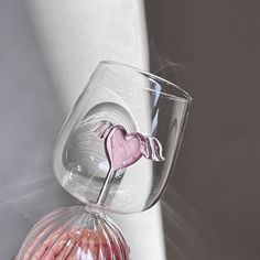 a glass vase with a pink heart on it