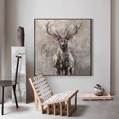 a chair sitting in front of a painting on the wall