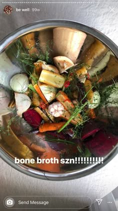 a metal bowl filled with lots of different types of vegetables