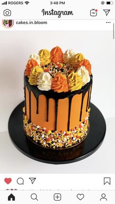 an orange and black cake with flowers on top is shown in the instagramr