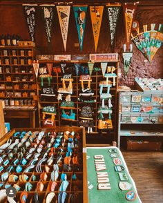 there are many cupcakes on display in the store with bunting flags above them