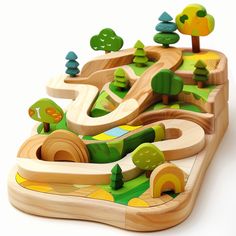 a wooden toy train set with trees and roads