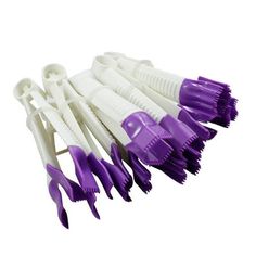 purple and white toothbrushes lined up in a row on top of each other