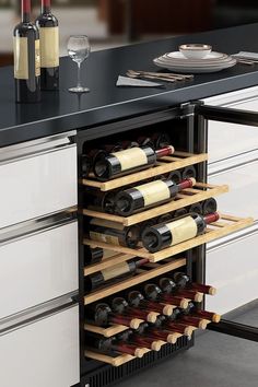 a wine rack with several bottles and glasses in it next to a kitchen counter top