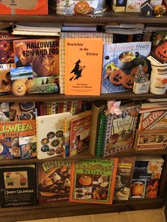 a bookshelf filled with lots of halloween books and other items on it's shelves