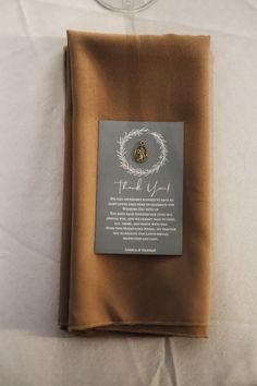 a folded piece of cloth with a label on it that says, thank you for the gift