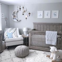 a baby's room with gray walls and white furniture