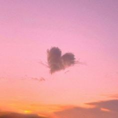 an airplane flying in the sky at sunset