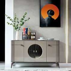 a modern sideboard with an abstract painting on the wall