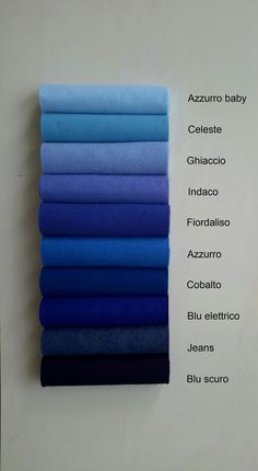 blue and purple sheets are stacked on top of each other in different colors, with the words azzuro baby written above them