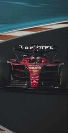 a red race car driving on a track