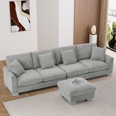 a living room with a gray couch and ottoman