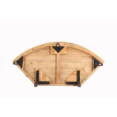 a wooden wall hanging with two black arrows on the front and one white arrow on the back