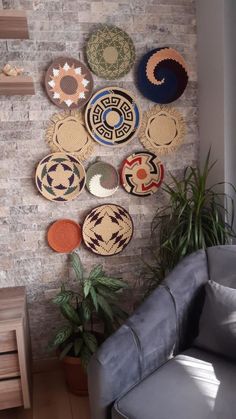 a living room filled with lots of different types of baskets on the wall above a couch