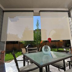 an outdoor dining area with table, chairs and sliding glass doors that look out onto the back yard