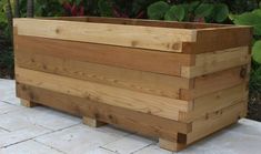 a wooden planter sitting on top of a white tiled floor