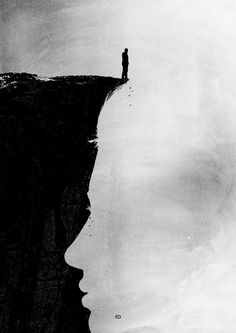 a black and white photo of a person standing at the edge of a cliff with water